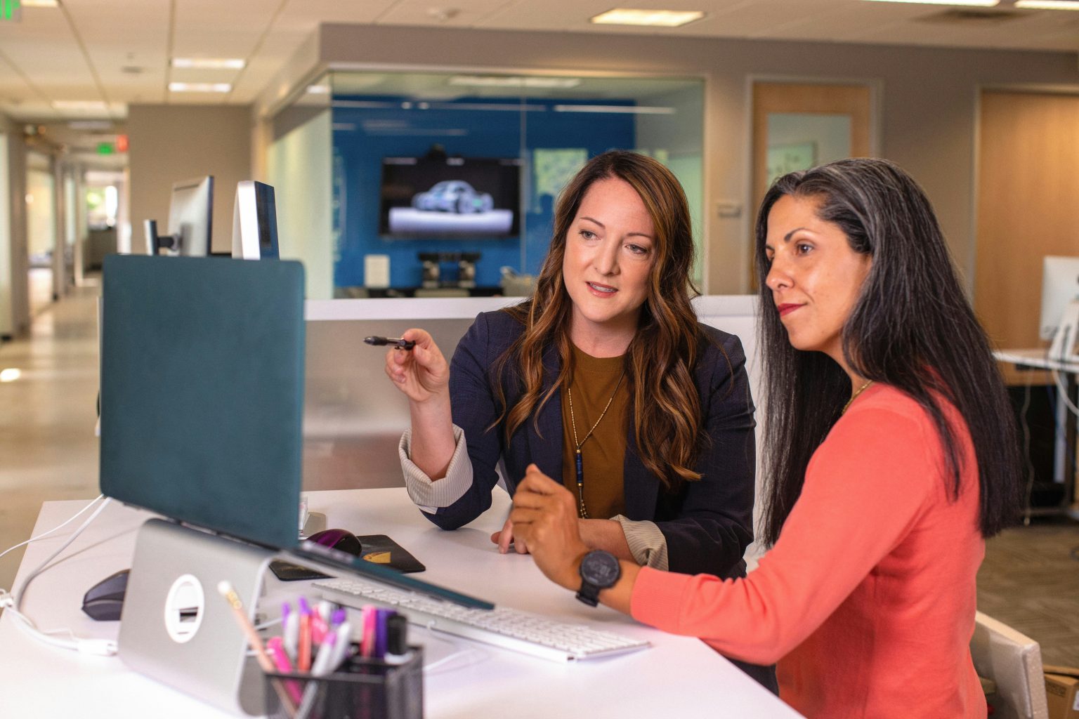 Two women discussing Google ads cost.
